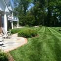 Large backyard with patio and rocking chairs