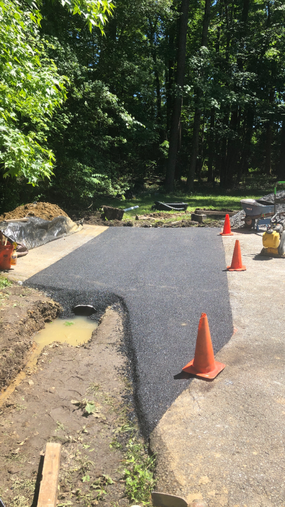 Fresh poured asphalt over culvert pipe