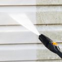 Power washing siding on house